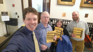 Team handing out gold standard at state house